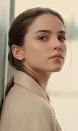 a woman with long hair and a turtleneck sweater looking off into the distance