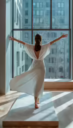 a woman in white is standing on a platform near a window