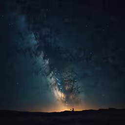 a silhouette of a person standing under a dark sky