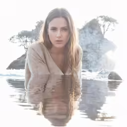 the woman is laying down on the water