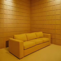 a tan leather couch in a beige room