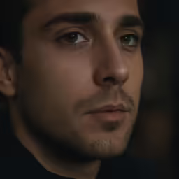 a close up of a man looking at the camera