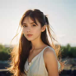 a young lady is wearing a white shirt and poses for a photo