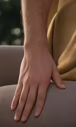 the back end of a persons arm on a cushion