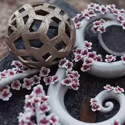 a ball and some flowers sitting on a granite