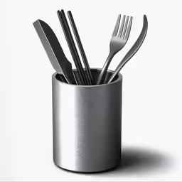a silver cup with forks, spoons and knives in it