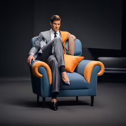 a man dressed in a business suit is sitting on a sofa