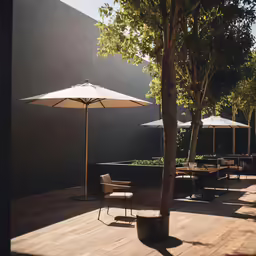 the sun is shining on patio seating and umbrellas