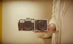 a person holding up a camera in their hands