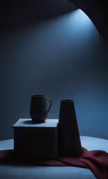 two black cups and a red towel in an oval room