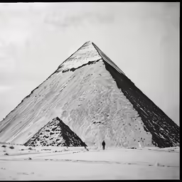 a person standing by the base of a mountain