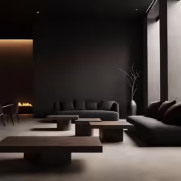 a couple of black couches are sitting in a room