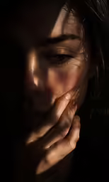 a woman with hands resting on her face