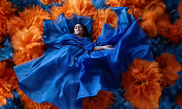 a woman is laying on a colorful background