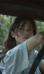 a woman sitting in the back seat of a car