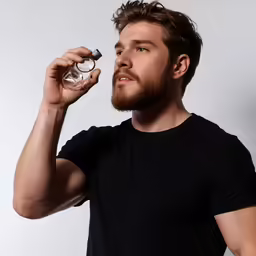 a man looking at something with one hand on his eye