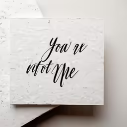 two square pieces of paper with handwriting on them