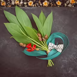 a bouquet of flowers sitting on top of a black surface