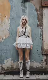 there is a young woman wearing boots and dress