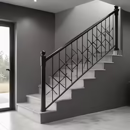 a white stairwell leading to an open door with a railing