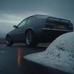 a gray car sits on the side of the road next to snow