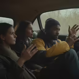 people sit in the back seat of a car