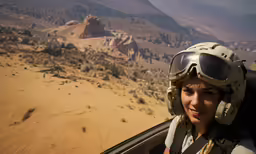 an image of a woman in the air with the desert behind her