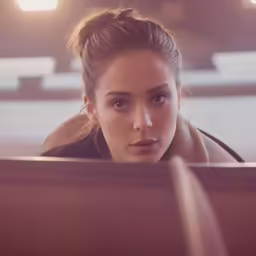 woman looking at computer screen with serious expression