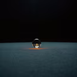a light bulb sitting on top of a wet surface