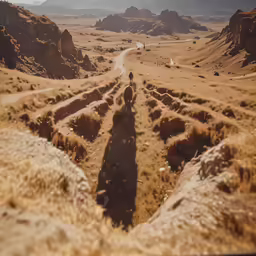 an aerial shot of a path in an open field