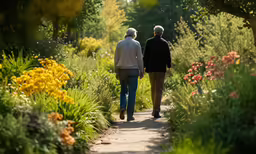 an older couple walking down a path together