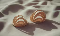 a couple of wooden seashells sitting on a bed